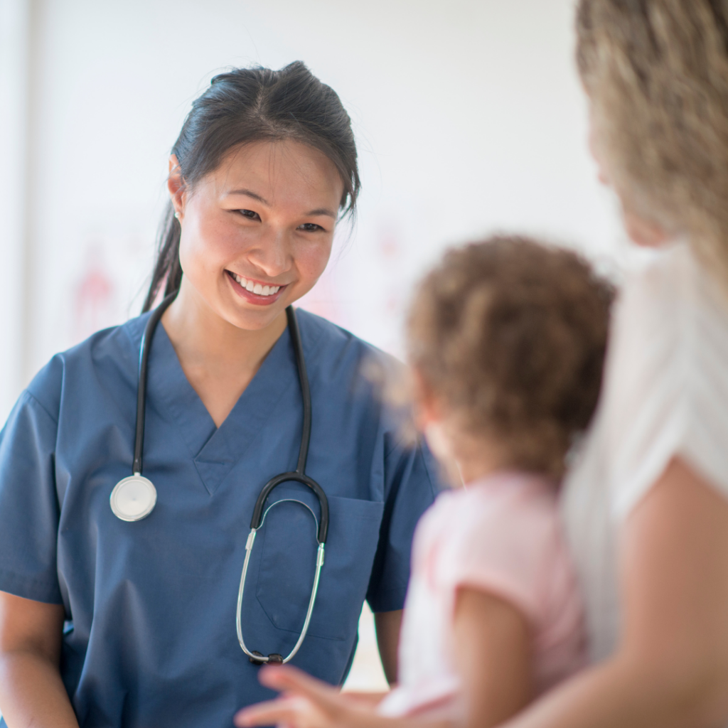 Female UCHealth employee smiles at pediatric patient